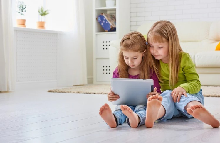 Cute sisters on tablet Remote Working 2